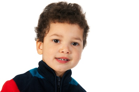 Little boy with black curly hair in the studio