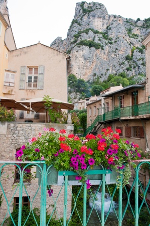 Saint Moustiers in France with mountains and balcony with flowersの写真素材