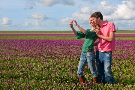 Couple Dutch tourists are taking pictures in the flower fieldsの写真素材