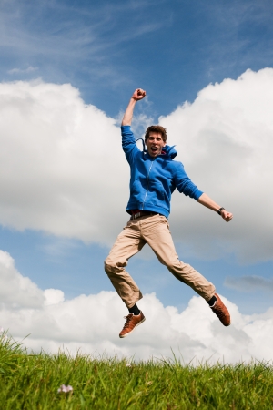 Happy jumping man outdoor in the fieldsの写真素材