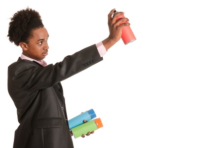 Studio portrait of a young African American man with graffiti aerosolsの写真素材