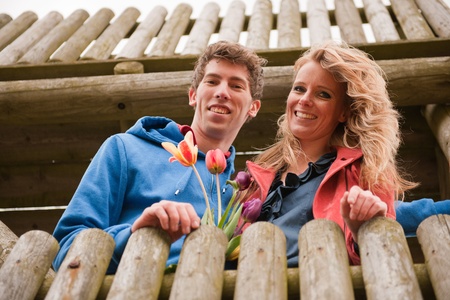Young couple in Dutch observation hut with flagの写真素材