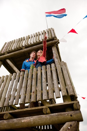 Young couple in Dutch observation hut with flagの写真素材