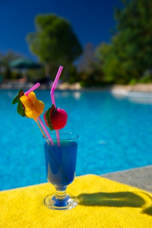 Blue Curacao cocktail at outdoor swimming poolの写真素材