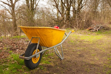 Yellow wheelbarrow from the gardenerの写真素材