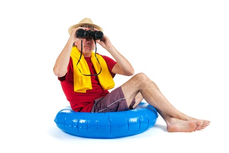 Tourist is sitting on float at the sea with binocularsの写真素材