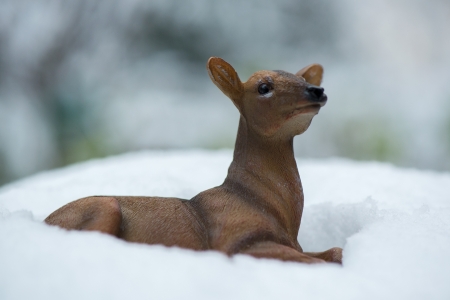 Little artificial Christmas deer outdoor in snowの写真素材