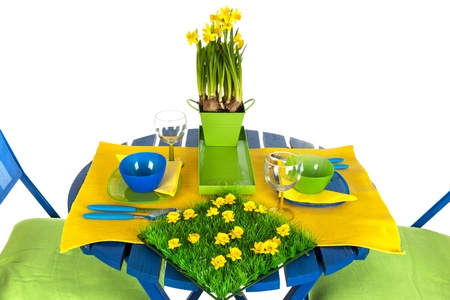 Easter table with blue and yellow over white backgroundの写真素材