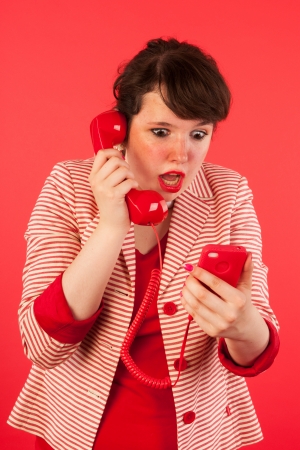 Young woman is having great news through her earphone connected at the smartphoneの写真素材