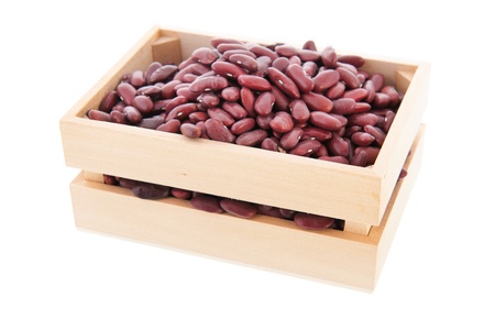 Wooden crate full with brown beans isolated over white backgroundの写真素材