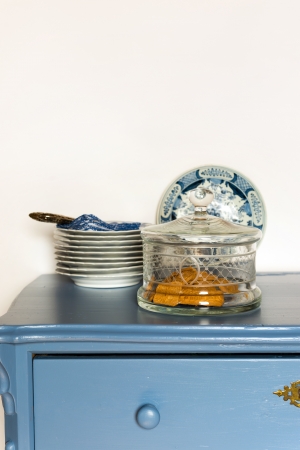 Lavender colored cabinet with old crockery and glass bowl cookiesの写真素材