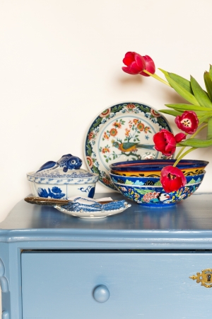 Lavender colored cabinet with old crockery and glass bowl cookiesの写真素材