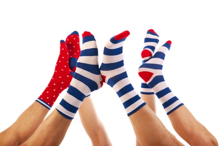 Feet in striped and dotted socks isolated over white backgroundの写真素材
