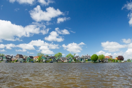 Row green wooden houses in typical Dutch villageの写真素材