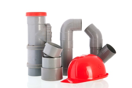 PVC tubes and pipes with red safety helmet