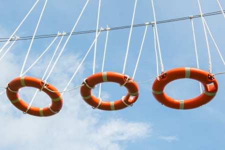 Climbing in the air with life buoysの写真素材