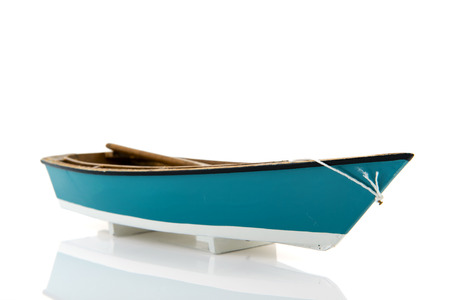 Blue miniature rowing boat isolated over white backgroundの写真素材