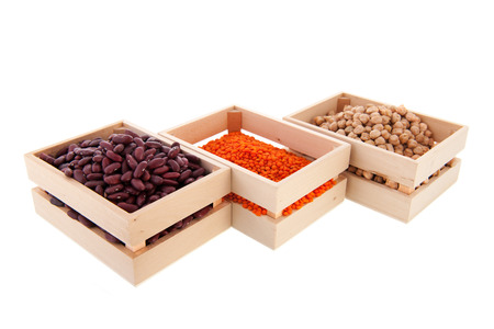 Wooden crates full with assortment legumes isolated over white backgroundの写真素材