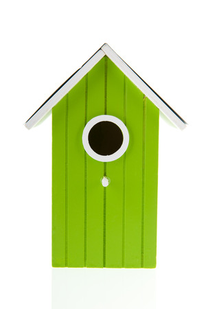 Green bird house with hole isolated over white backgroundの写真素材