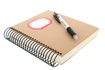 paper notebook with pencil isolated over white backgroundの写真素材
