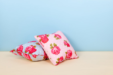 colorful pillows with roses at the floorの写真素材