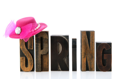 spring in vintage print letters with pink hatの写真素材