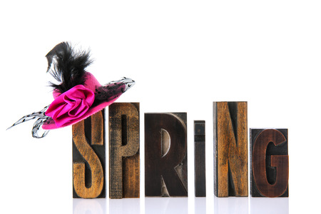 spring in vintage print letters with pink hatの写真素材