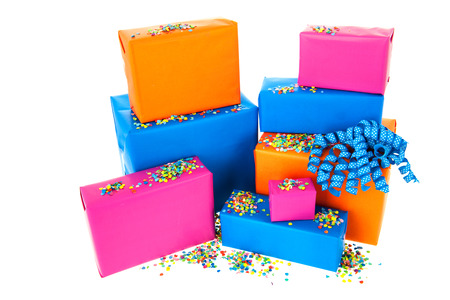 Pile gifts in many colors with confetti isolated over white backgroundの写真素材