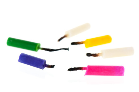 after the party with used birthday candles isolated over white backgroundの写真素材