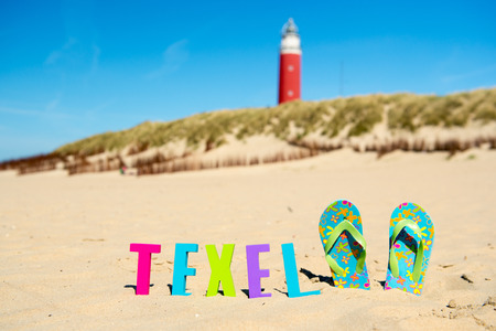 Texel Dutch wadden island with lighthouse and flip flopsの写真素材