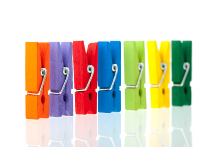 colorful wooden clothes pins isolated over white backgroundの写真素材