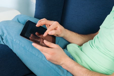 Working with tablet and swiping for informationの写真素材