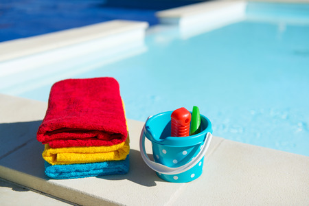 Toys and towels at the swimming poolの写真素材