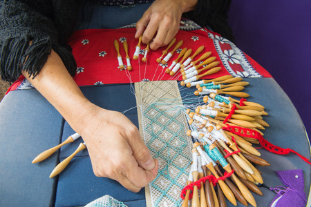 Woman making bobbin lace の写真素材