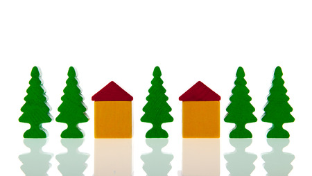 small village in colorful wooden blocks with church and trees isolated over white backgroundの写真素材