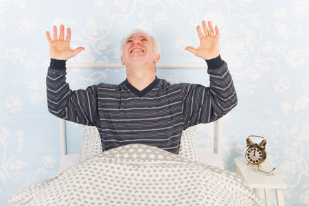 Man at night having problems with noise from the neighbours aboveの写真素材