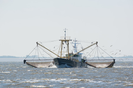 fishing boat with nets on Dutch wadden sea