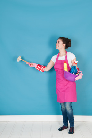 Young woman with full equipment to clean the interiorの写真素材