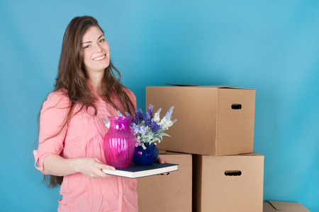 woman unpacking boxes while moving house