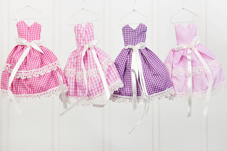 Pink dresses hanging at hangers at the wallの写真素材