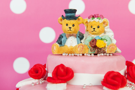 Funny couple bears on pink wedding cakeの写真素材