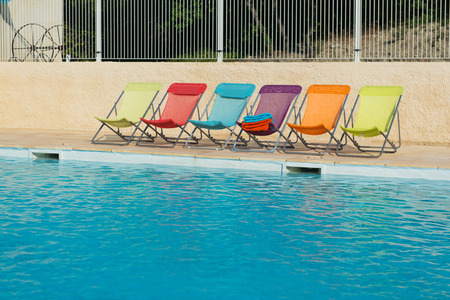 Row colorful chairs at the swimming poolの写真素材