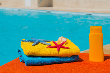 Towels in blue and yellow at the swimming poolの写真素材