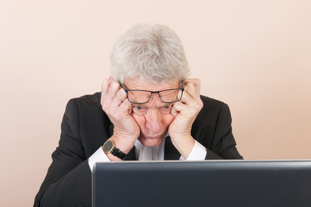 Senior man working with laptop at the office