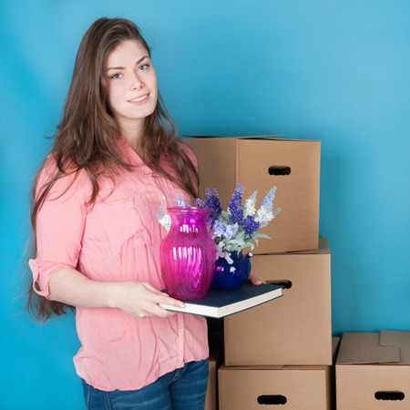 woman unpacking boxes while moving house