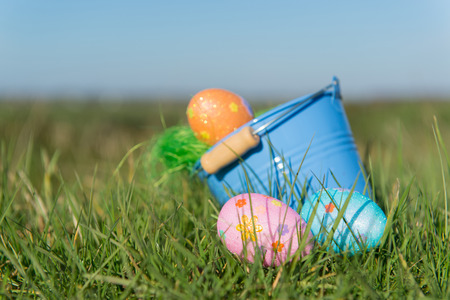 Bucket with chocolate easter eggs outdoor in the garden