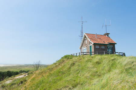 Little house with many antennes at Dutch wadden island Terschellingのeditorial素材
