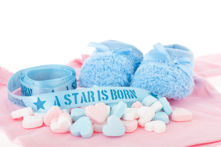 Newborn boy with blue and pink candy heartsの写真素材