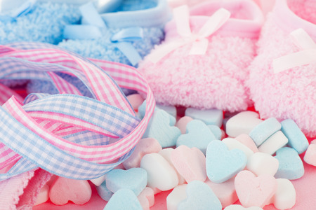 Newborn with candy hearts in pink and blue