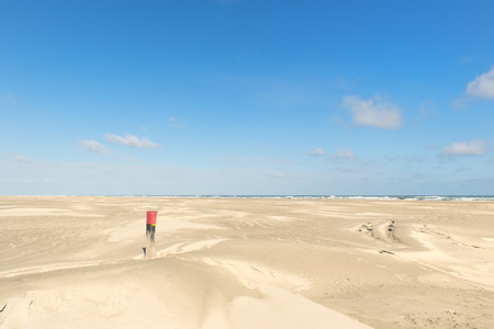 Red wooden pole at the beachの写真素材